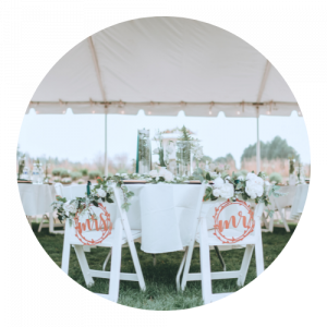Chairs and tables under big tent on wedding lawn at Falling Water Gardens Wedding and Event venue near Seattle, located in Monroe, WA.